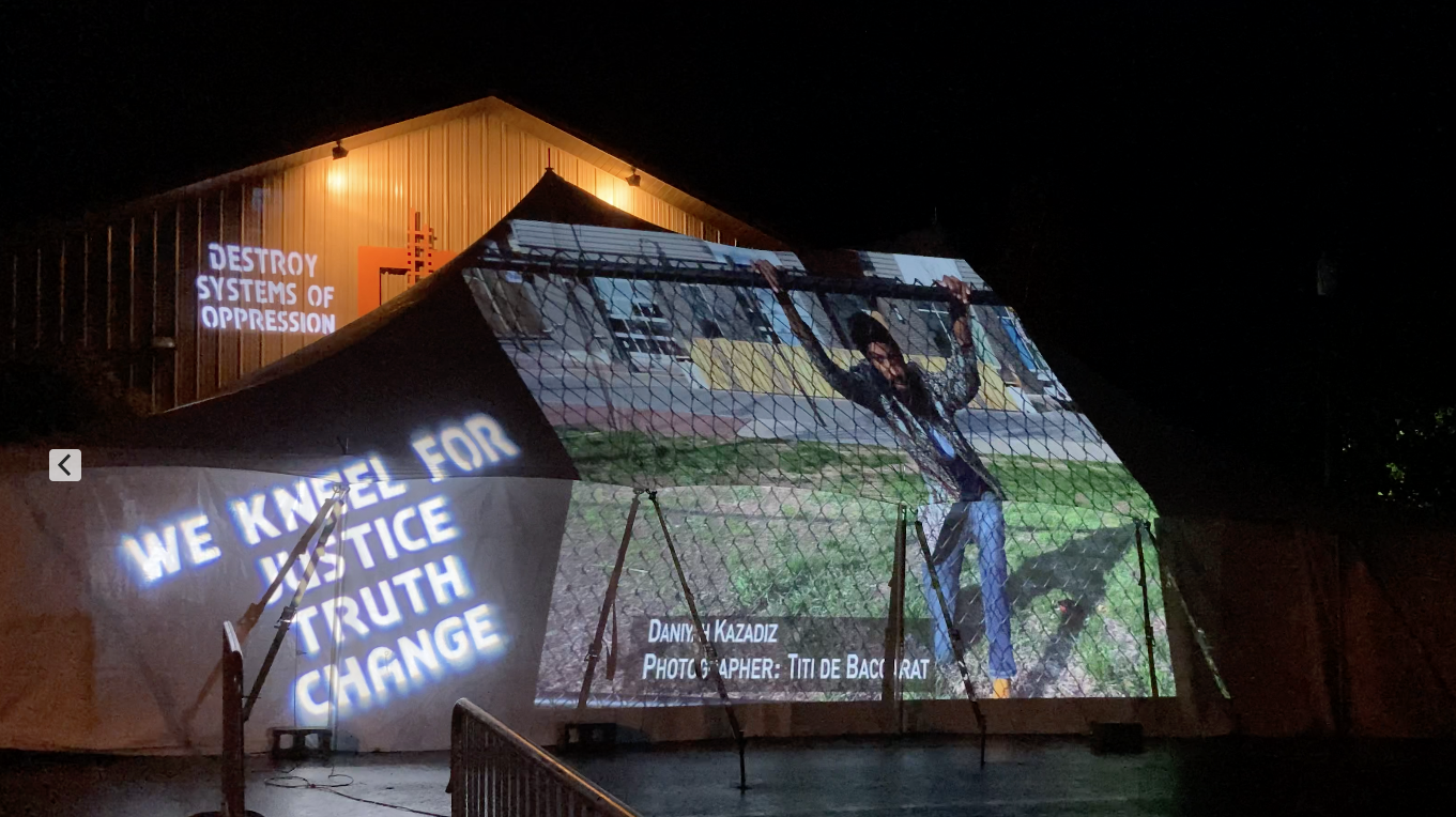 ext. Dan behind fence